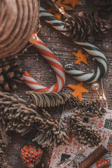 Fototapeta premium Christmas decorations on a wooden background toys Christmas tree cones lollipops sequins