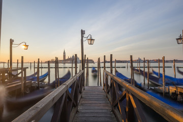 Fototapeta premium Gondolas docked at the pier in Venice