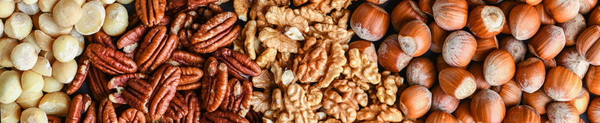 Mix nut wide banner or panorama. Natural healthy food background made from different kinds of nuts.