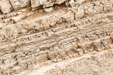 Texture, background layers and cracks in sedimentary rock on cliff face. Cliff of rock mountain....