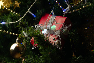  Christmas gift with decorations hanging from Christmas tree