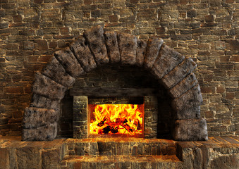 Classic isolated rustic fireplace made of stones lit with orange fire flames.