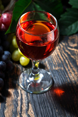 glass of red wine on wooden background