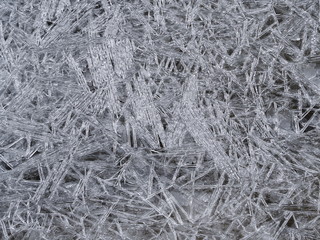 Crushed clear ice formation on the river shore. Background pattern close up.