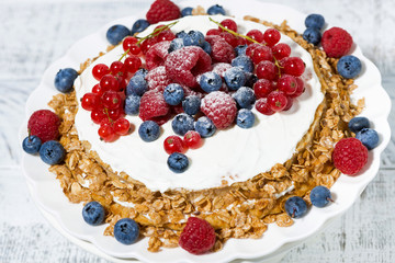healthy oatmeal cake with yogurt and fresh berries, closeup top view