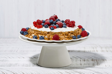 healthy oatmeal cake with yoghurt and fresh berries on a stand