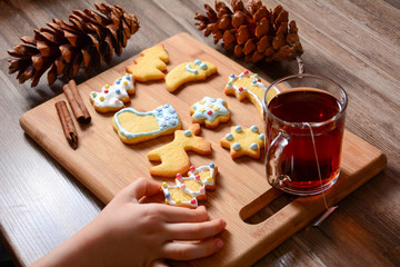 Cookies for christmas different shapes. Top view of children fingers touch Christmas cookies and biscuits, copy space