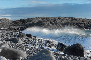 Brihgt day  by the spectacular stony sea coast in storm weather in  South Norway