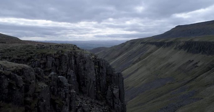 Aerial drone shot a valley called High Cup Gill in Cumbria, England on a cloudy day.