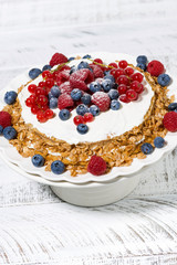 healthy oatmeal cake with yogurt and fresh berries, vertical top view