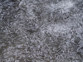 Crushed clear ice formation on the river shore. Background pattern close up.