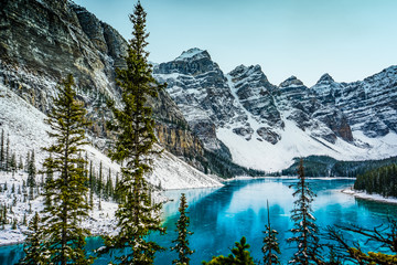 Moraine lake panorama in winter with frozen water and snow covered mountains, Banff National Park, Alberta, Canada - obrazy, fototapety, plakaty