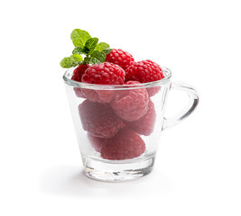 Lot of fresh raspberry in glass cup isolated on white