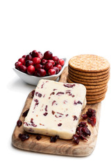 Cranberry cheddar cheese with wheat crackers isolated on white