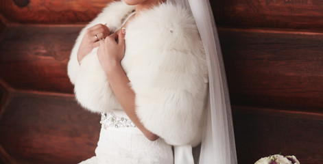 rich bride in a white fur coat. wedding concept