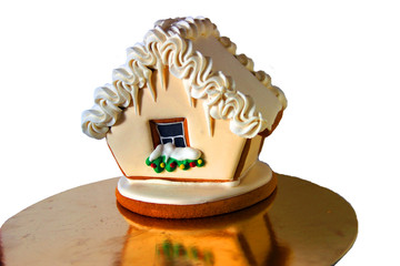 Photo of a ginger santa cookie house on the golden tray. Christmas decoration