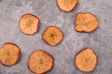 Dried apple on a structured grey background