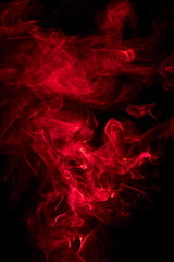 Fototapeta na wymiar Red smoke on black background