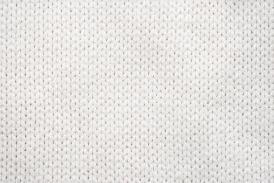 White Knit Fabric Background. Wool Sweater Texture Close Up