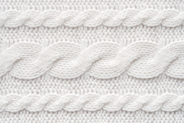 Fototapeta na wymiar White Knit Fabric Background. Wool Sweater Texture Close Up