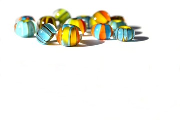 Beautiful colorful background made of lampwork beads isolated on white background. Suitable for text input.