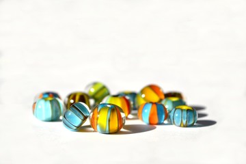 Beautiful colorful background made of lampwork beads isolated on white background. Suitable for text input.