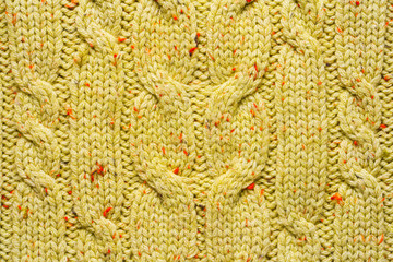 Texture of Wool Knit Color of Mustard Fabric Interspersed with Red Orange Yarn. Sweater Background Close-Up View