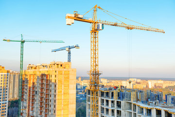 Construction with cranes on industrial building site