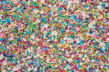 Colorful confetti sprinkles textured background
