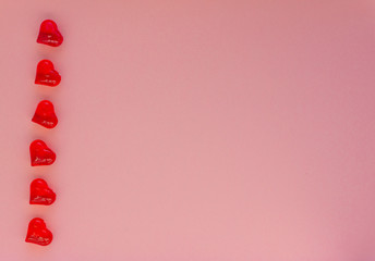 Hearts on a pink background. Valentin's Day, top view. Copy space. Flat lay. Greeting card.