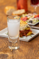 greek ouzo with moussaka on wood