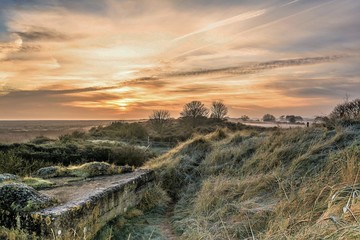 Fototapeta na wymiar Saltmarsh sunrise from dunes