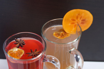 Drink red and yellow in glass goblets. Anise stars, dried mandarin rings, a slice of persimmon float in it.