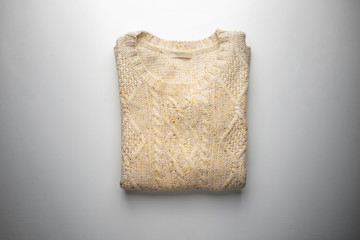 Beige sweater on white view from above