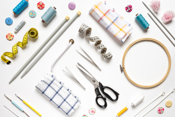 Sewing flat lay top view Composition with threads and sewing accessories on wnite background, flat lay banner