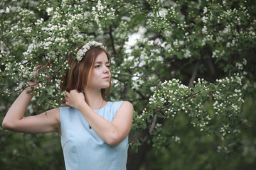 Girl in blue dress in green park