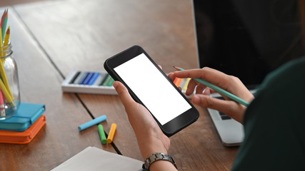 Creative woman using her smartphone on stylish table.