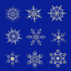 Fototapeta na wymiar Silver snowflakes on a blue background.