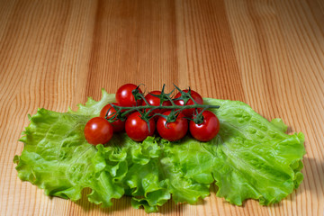 tomatoes and lettuce on wooden board
