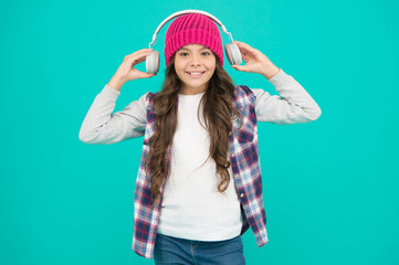 too loud. teenager listen music in headset. audio book for little kid. self education online. small child long hair enjoy sound. happy childhood. happy hipster girl turquoise background