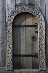 wooden door with artful wood carving ornaments of a viking church