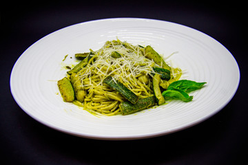 Zucchini paste and pesto sauce on black background