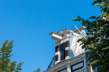 Classic old house facade with blue sky in Amsterdam