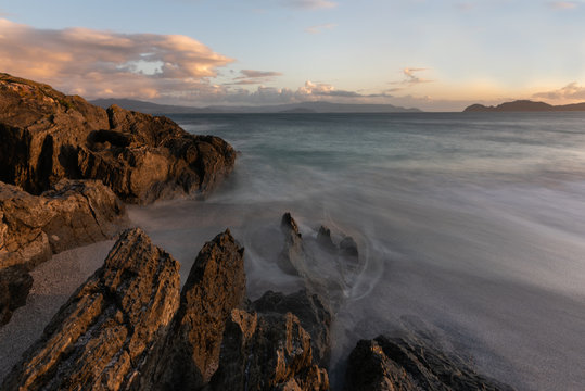 Beautiful exposure long in a rocky beach at sunset, sunrise, with a cloudy sky in San Vicente do Mar, A Lanzada, O Grove, Sanxenxo, Pontevedra, Galicia, Spain.