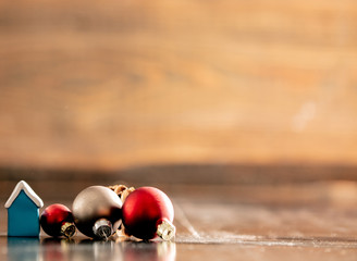 Little house and Christmas toys on wooden table
