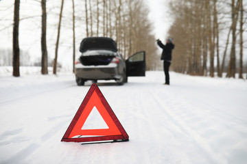 Man and car. Winter walk and car repair.