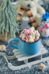 Winter warming sweet drink hot chocolate with marshmallows and cocoa in mug