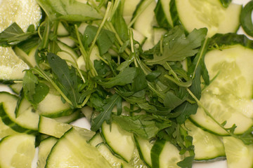 Vegetable salad closeup. Cucumbers arugula .