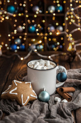 Cup of coffee with marshmallow, gingerbread on Christmas wooden background.