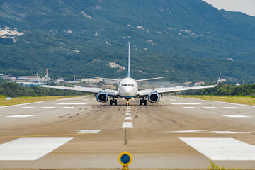 Sunny view of airplane taking off from airport of Tivat, Montenegro.
